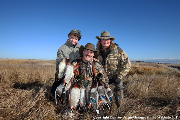 Family with bagged mallards. 