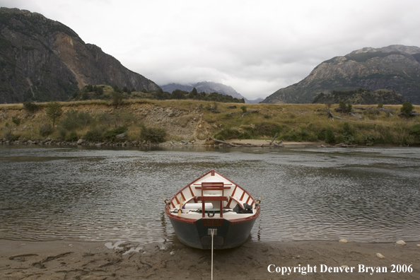 Driftboat beached on riverbank.