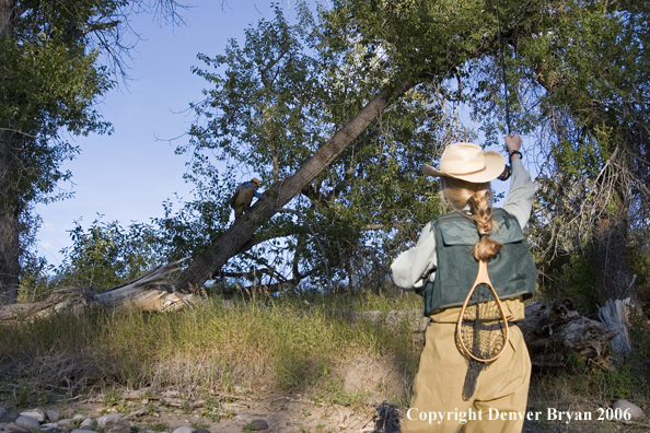 Woman flyfisher and flyfisherman undoing a snag.