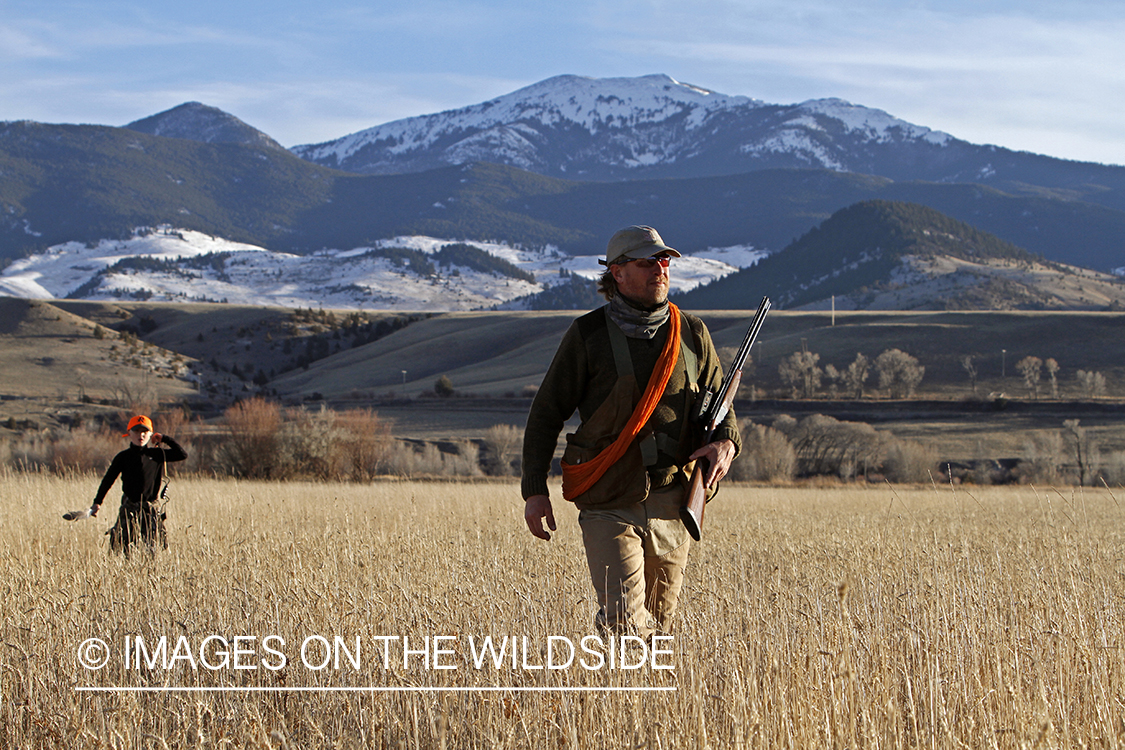 Father and son pheasant hunting.