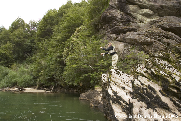 Flyfisherman casting from high bank.