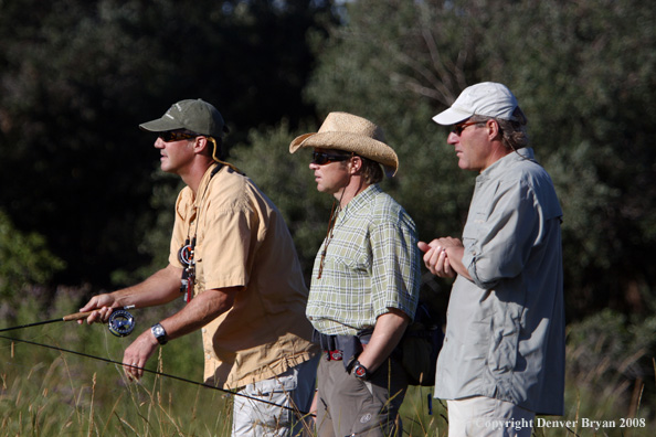 Flyfishermen fishing stream 