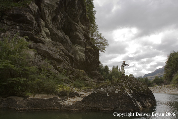 Flyfisherman casting from high bank.