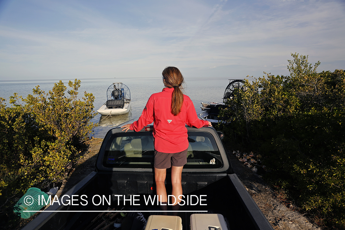 Woman arriving at airboat to go flyfishing.