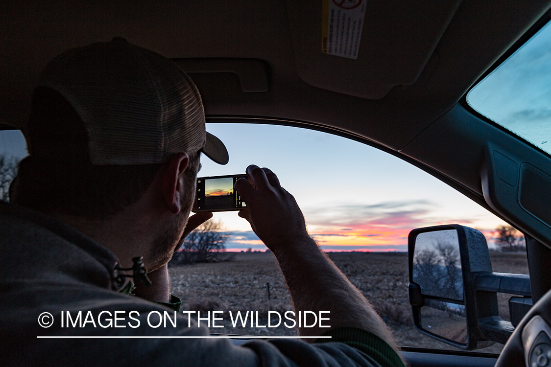 Hunter enjoying sunrise before day of goose hunting.