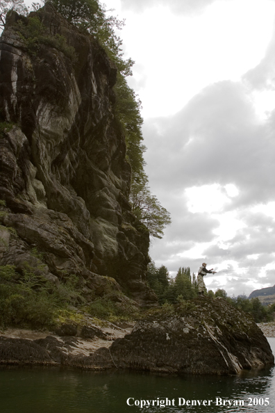 Flyfisherman casting from high bank.