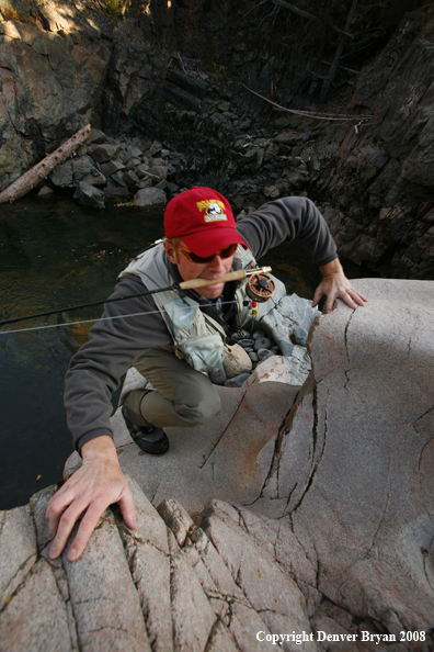 Flyfisherman climbing up Slot Canyon