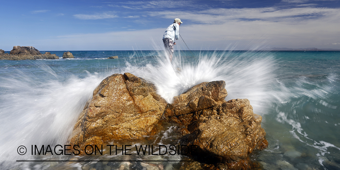 Flyfisherman fishing for roosterfish on beach.