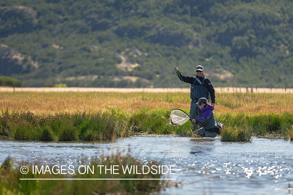 Woman fly fishing guide(Marcela Appelhanz) on stream.