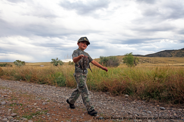 Young Dove Hunter carrying bagged doves