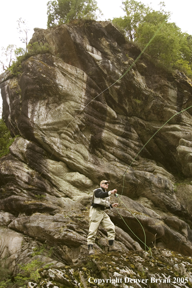 Flyfisherman casting from high bank.