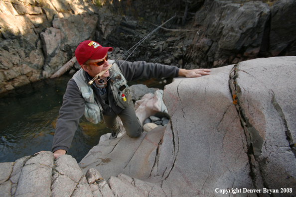 Flyfisherman Climbing up Slot Canyon