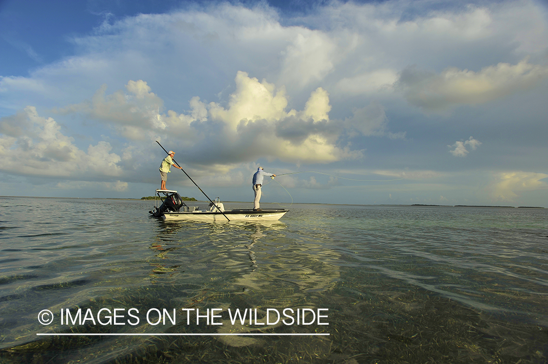 Flyfisherman casting from flats boat.