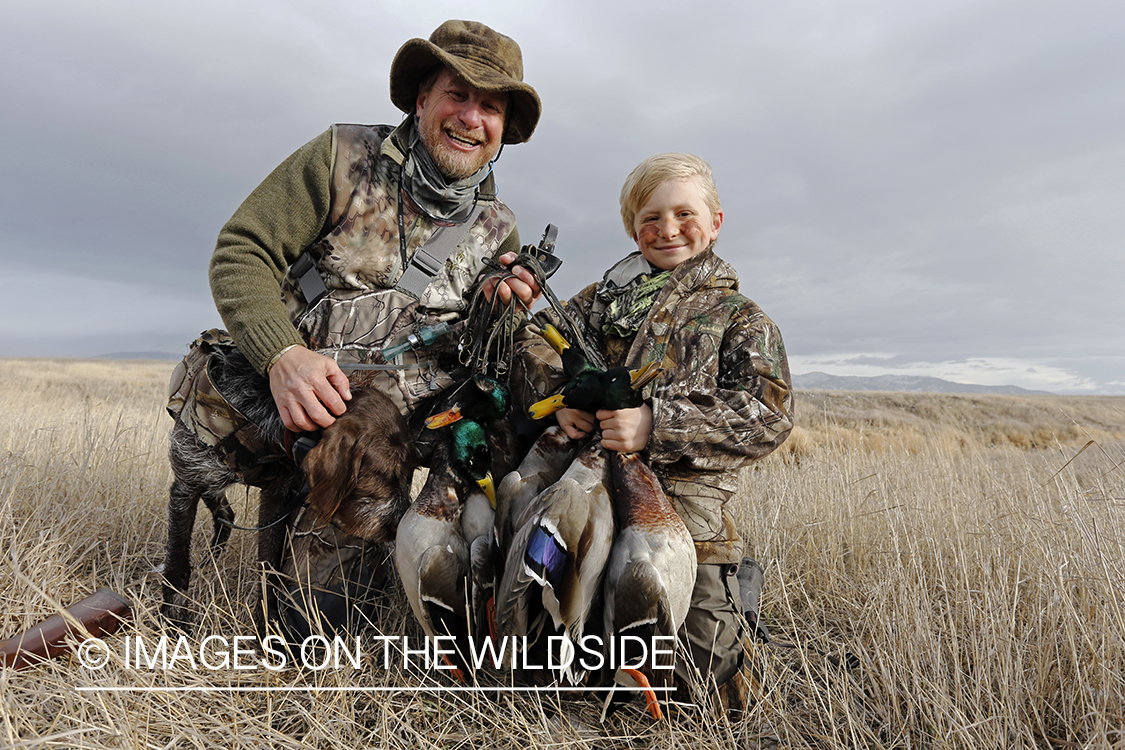 Father and son with bagged waterfowl.