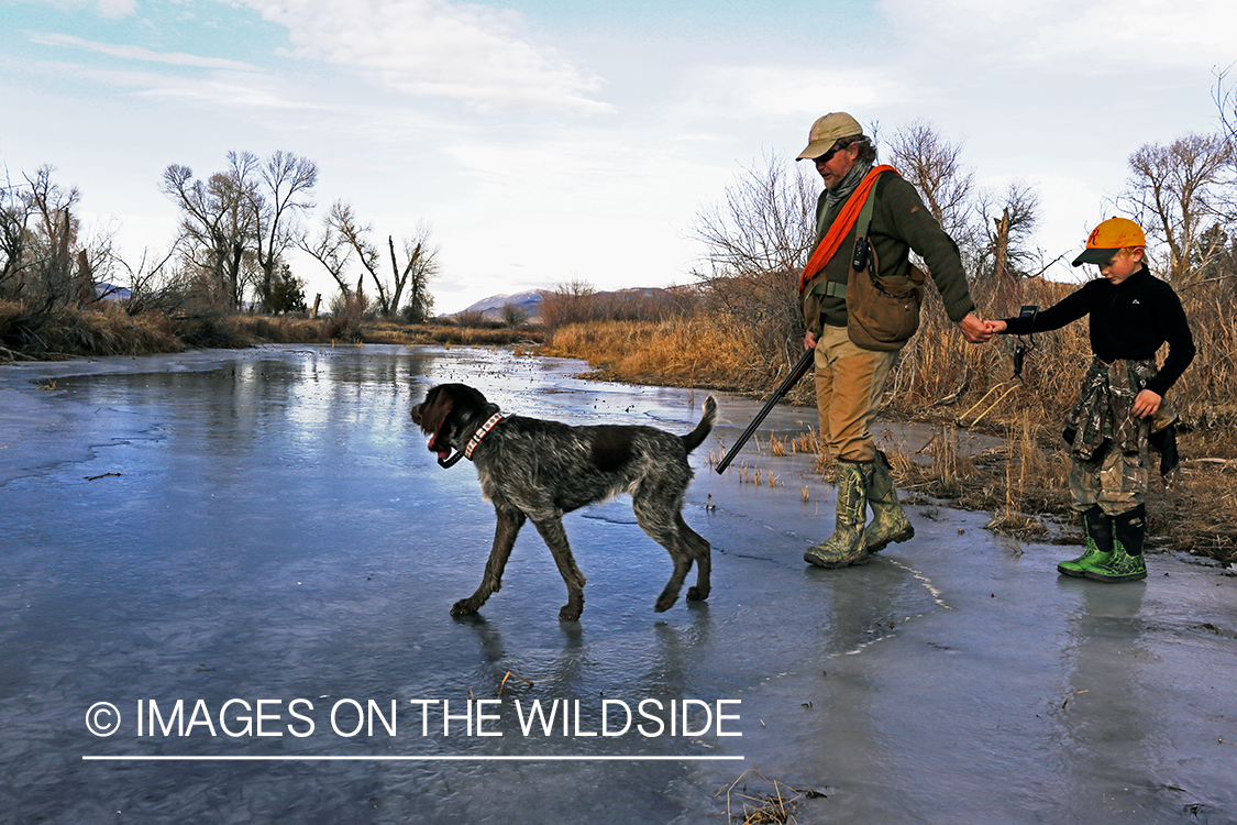 Father and son pheasant hunting.