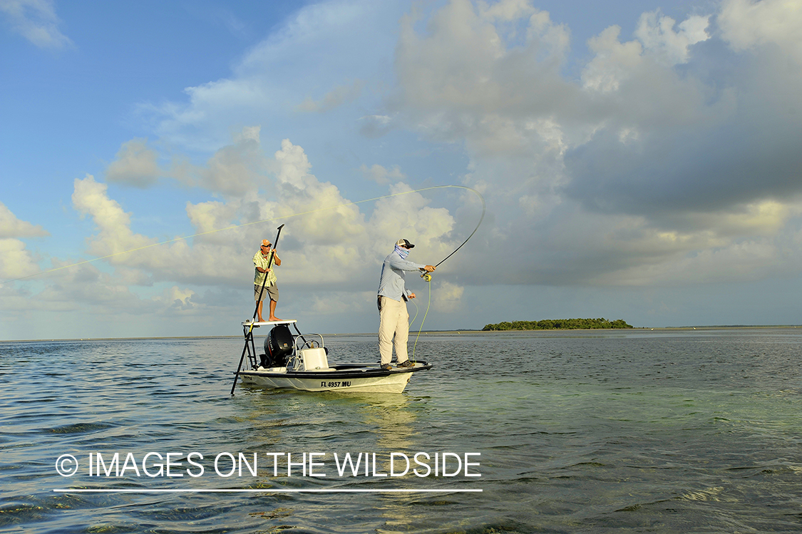 Flyfisherman casting from flats boat.