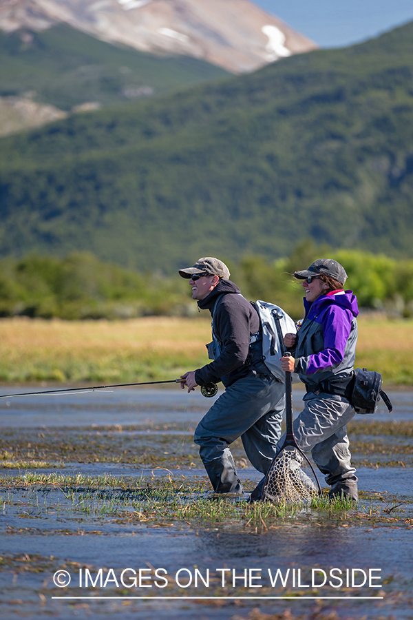 Woman fly fishing guide(Marcela Appelhanz) on stream.