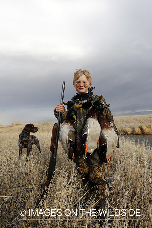 Father and son with bagged waterfowl.