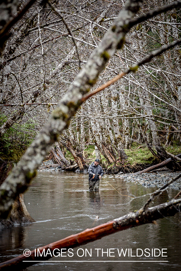 Flyfisherman on stream in late fall.