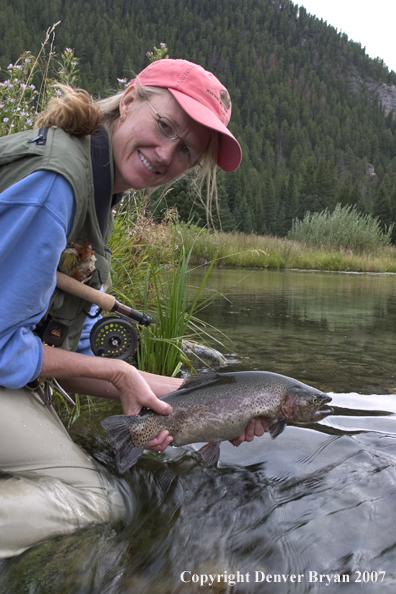 Woman Flyfisher with rainbow trout.