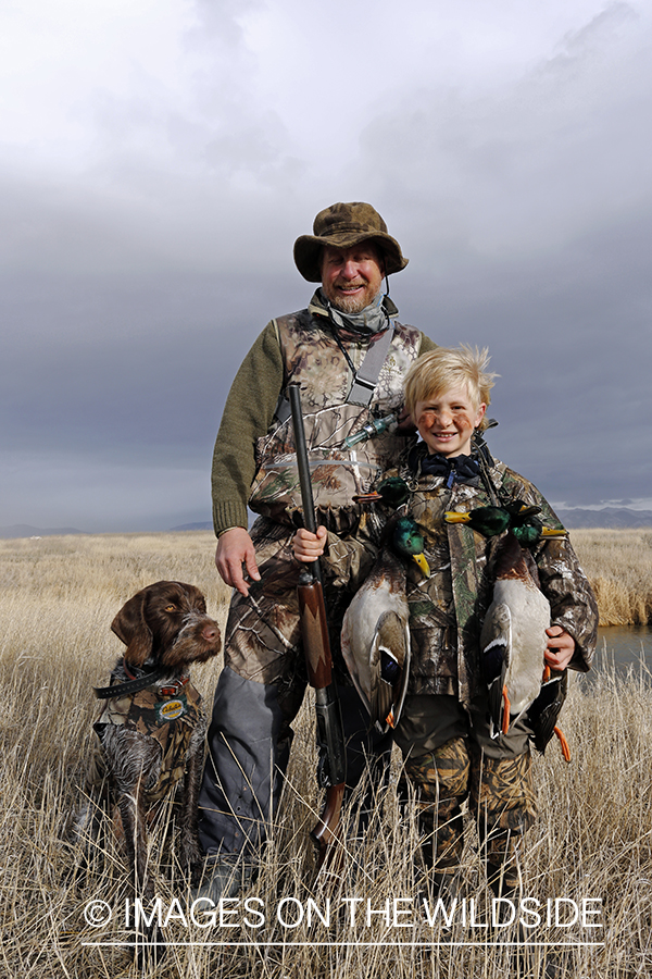 Father and son with bagged waterfowl.