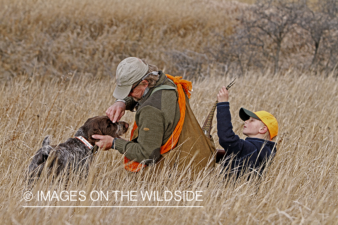 Father and son pheasant hunting. 