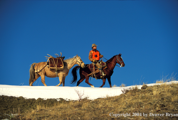 Big game hunter on horseback.