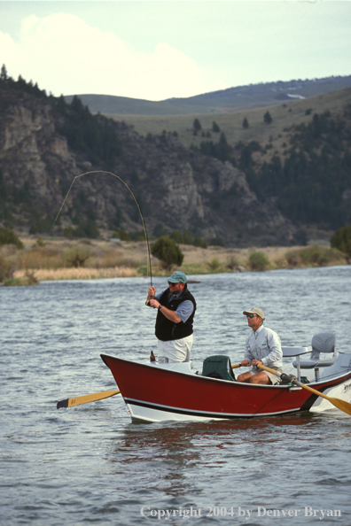 Flyfishermen fishing from driftboat.