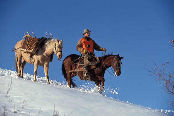 Big game hunter on horseback.