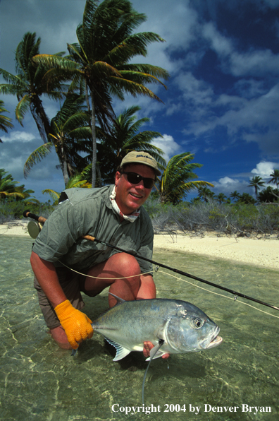 Saltwater flyfisherman holding trevally.