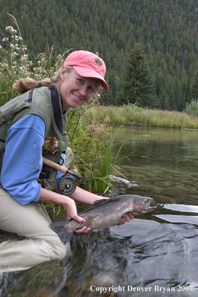 Woman Flyfisher with rainbow trout.