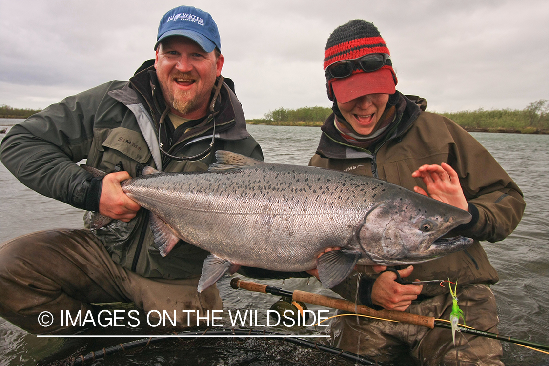 Fisherman and woman with nice salmon catch.