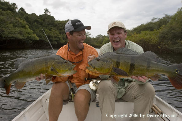 Fishermen holding Peacock Bass