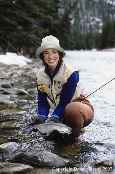 Female flyfisher with rainbow trout.