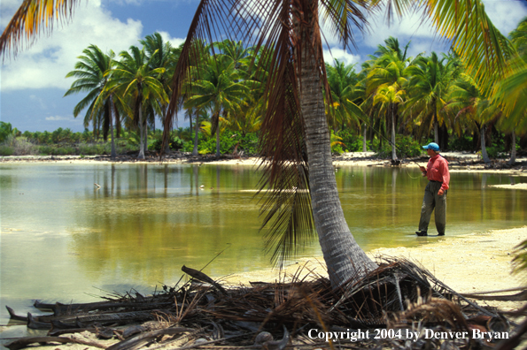 Saltwater flyfisherman walking on beach