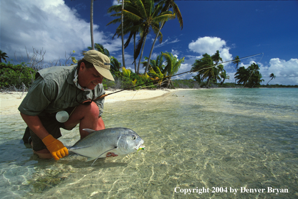 Saltwater flyfisherman holding trevally.