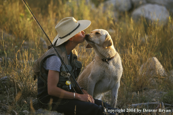 Woman flyfisher with yellow Lab.