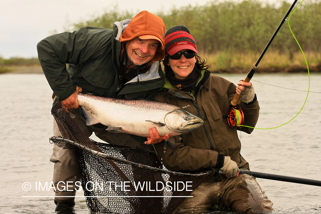 Fisherman and woman with nice salmon catch.