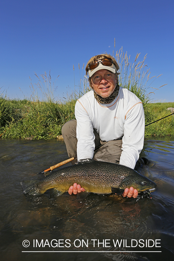 Flyfisherman with large brown trout. (10lbs)