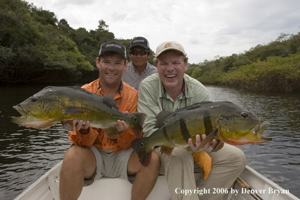 Fishermen holding Peacock Bass