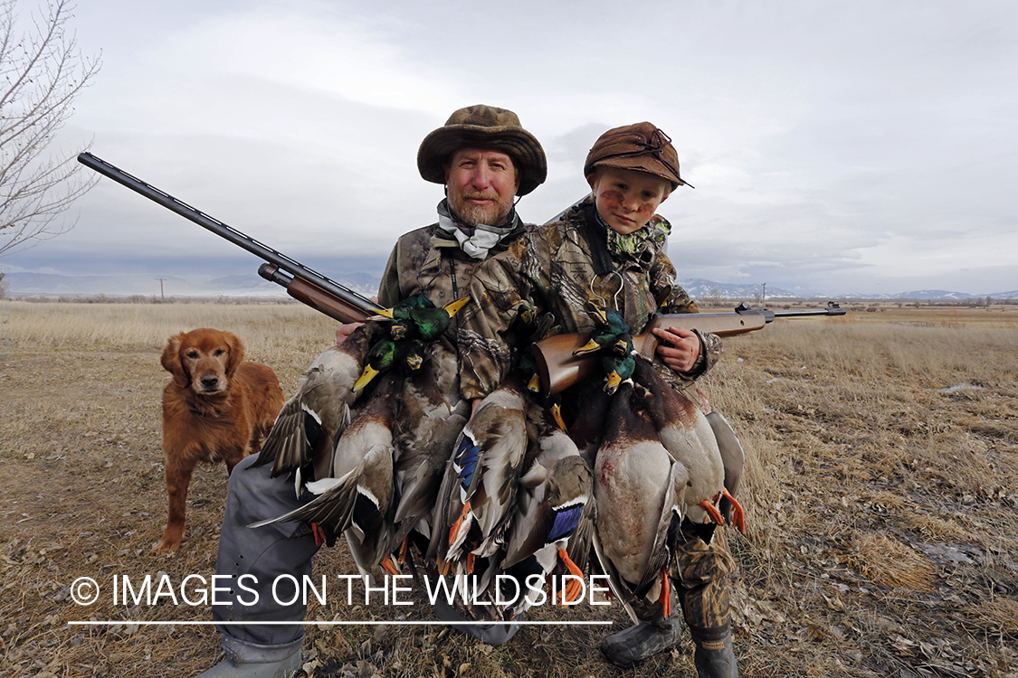 Father and son with bagged waterfowl.