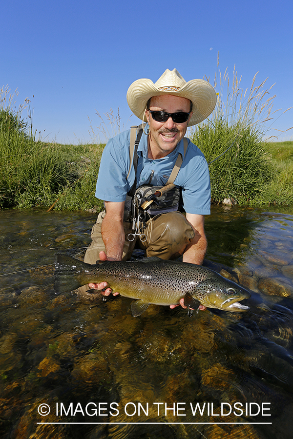 Flyfisherman with large brown trout. (10lbs)