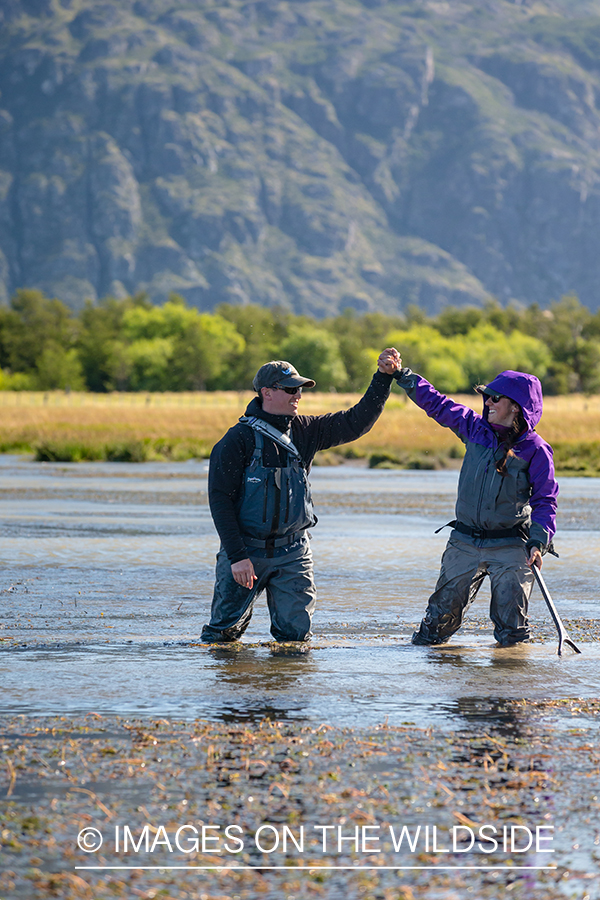 Woman fly fishing guide(Marcela Appelhanz) on stream.