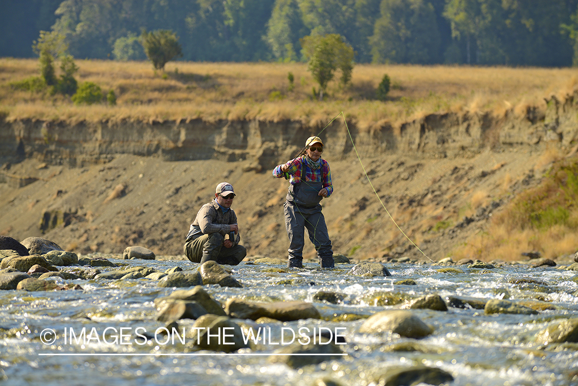 Flyfishermen on river in Chile.