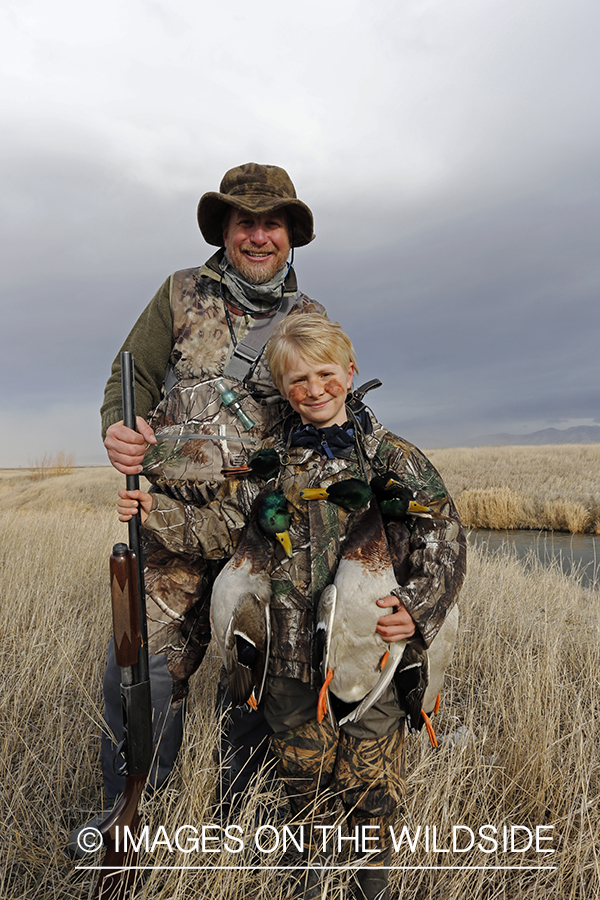 Father and son with bagged waterfowl.