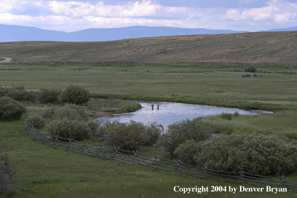 Flyfishermen fishing river.