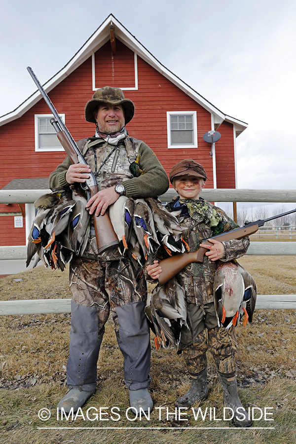 Father and son with bagged waterfowl.