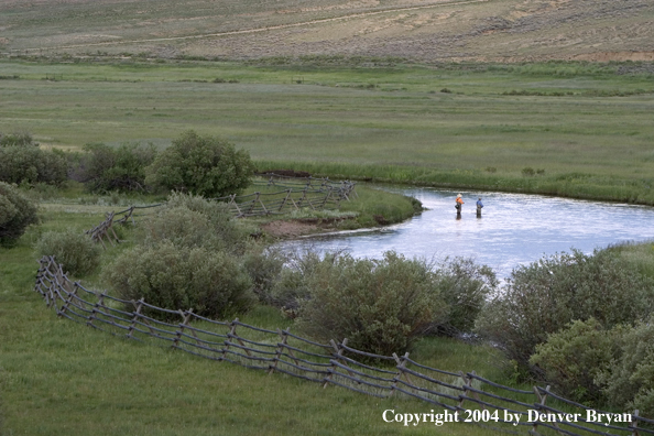 Flyfishermen fishing river.