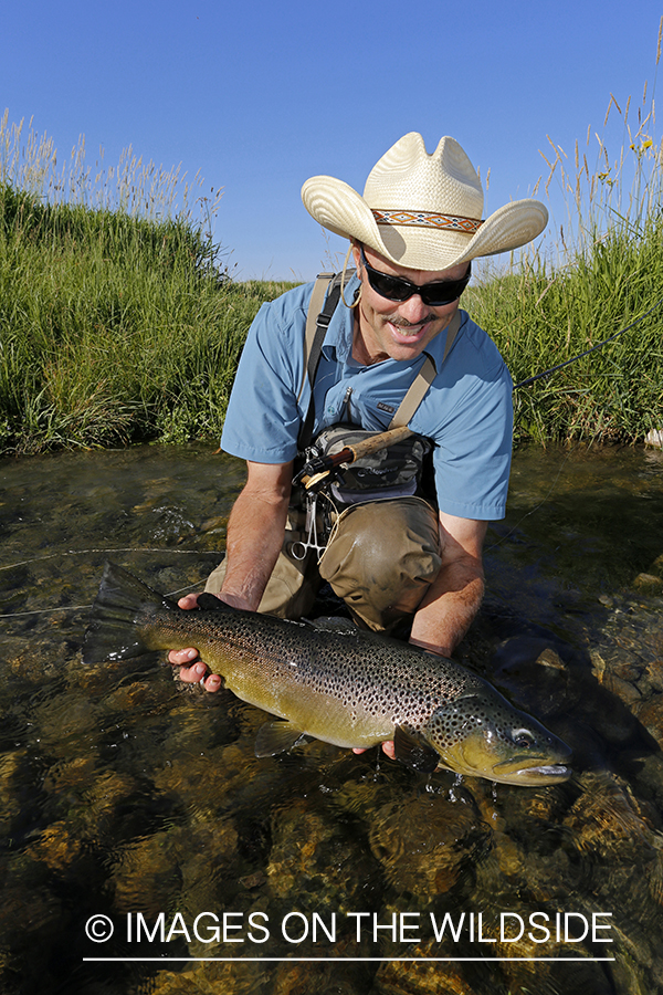 Flyfisherman with large brown trout. (10lbs)