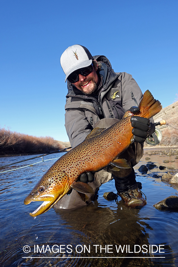 Flyfisherman with brown trout.